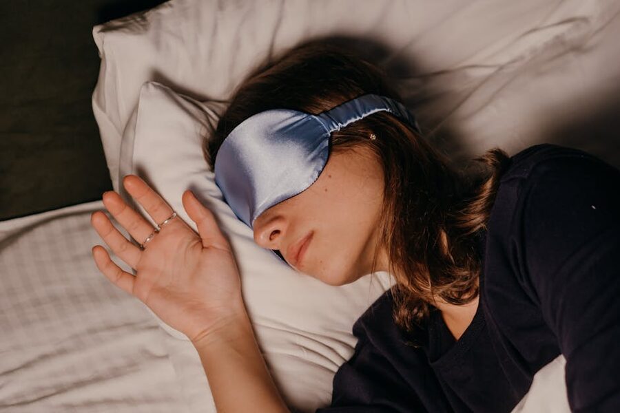 Person wearing a sleep mask resting indoors