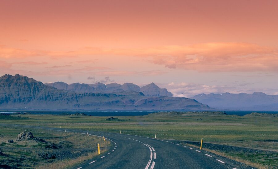 Iceland summer road through landscape with mountains and clouds