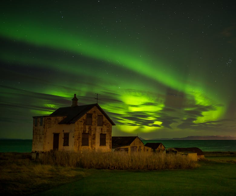 Aurora borealis over a small cottage on the Keflavik coast