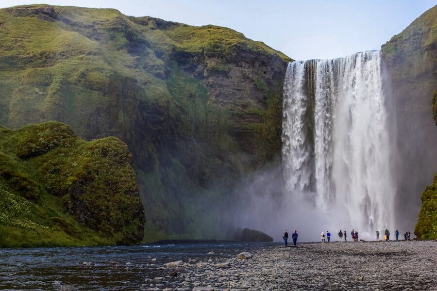 Skogafoss waterfall with tourists for scale