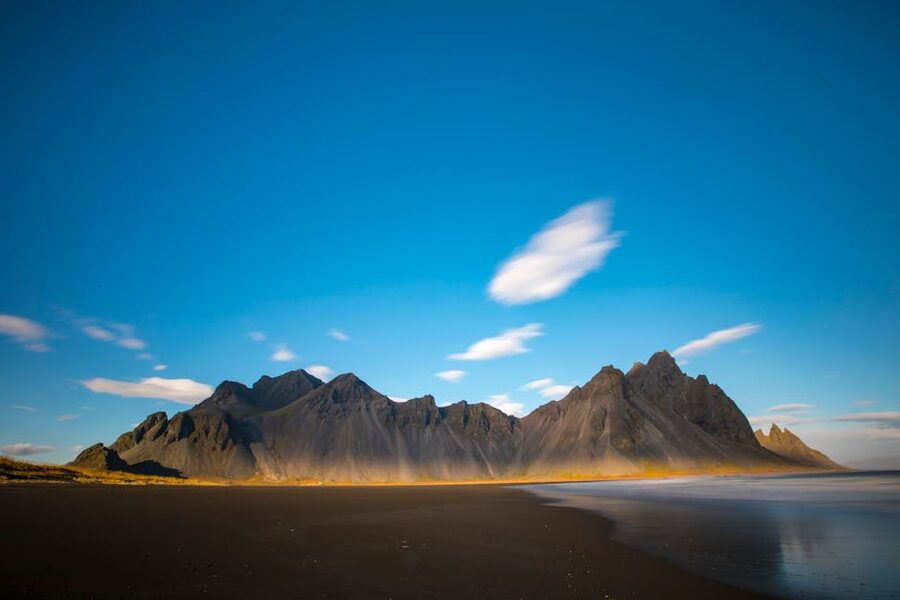 Vestrahorn mountain reflected in wet black sand at Stokksnes, Iceland