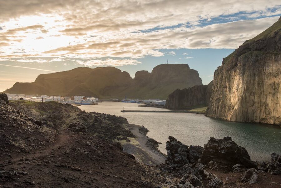 Heimaey island cliffs and harbour at sunset, Westman Islands