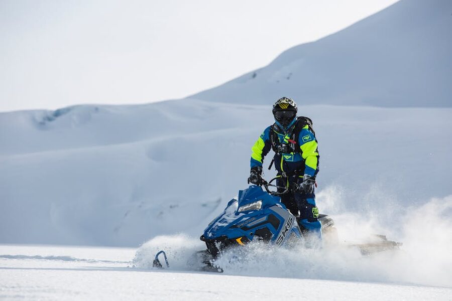 Snowmobile rider on snowy mountain landscape