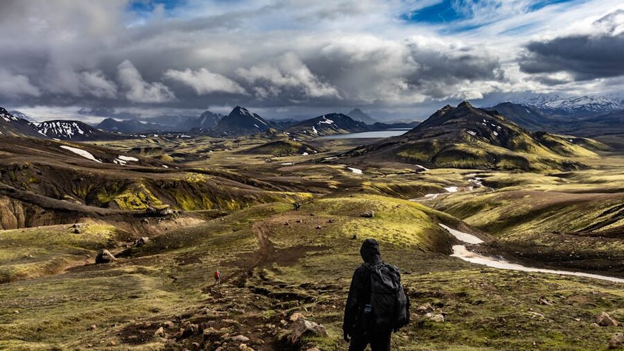 A hiker exploring the rhyolite mountains of Landmannalaugar