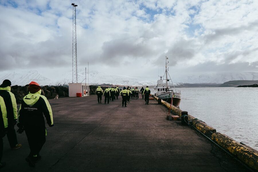 Group of tourists ready for a whale watching tour at Arskogssandur harbour Iceland