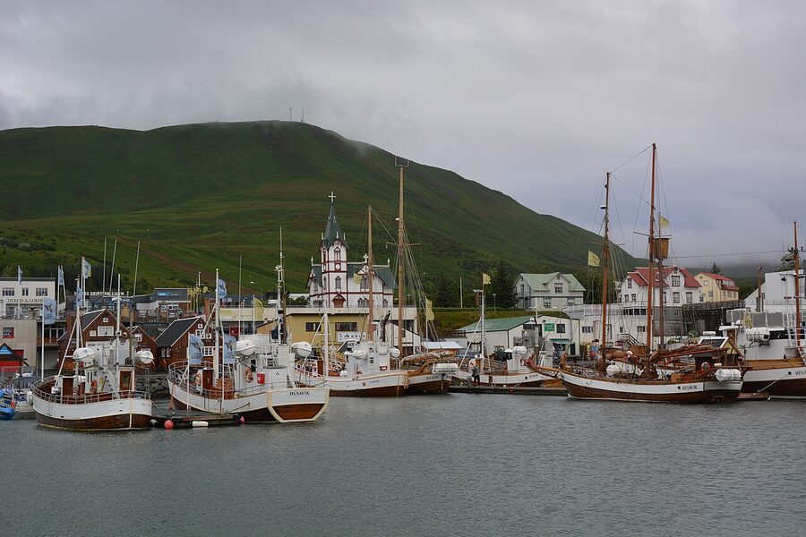 Husavik harbour in north Iceland with traditional fishing boats