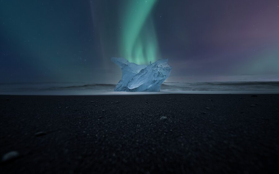 Glistening ice chunks washed up on the black sand of Diamond Beach Iceland