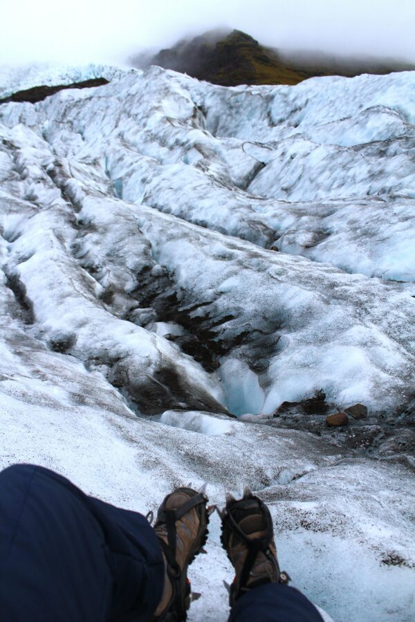 Hikers crossing the blue ice of an Icelandic glacier