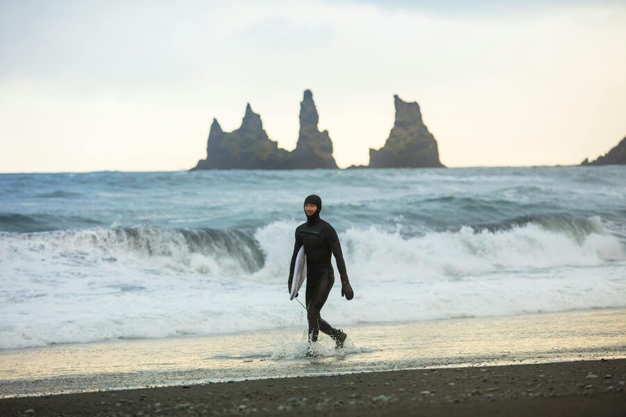Surfer pulling into a clean wave on the Iceland coast