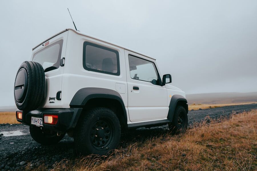 Off-road SUV on a gravel path in Iceland's rugged landscape