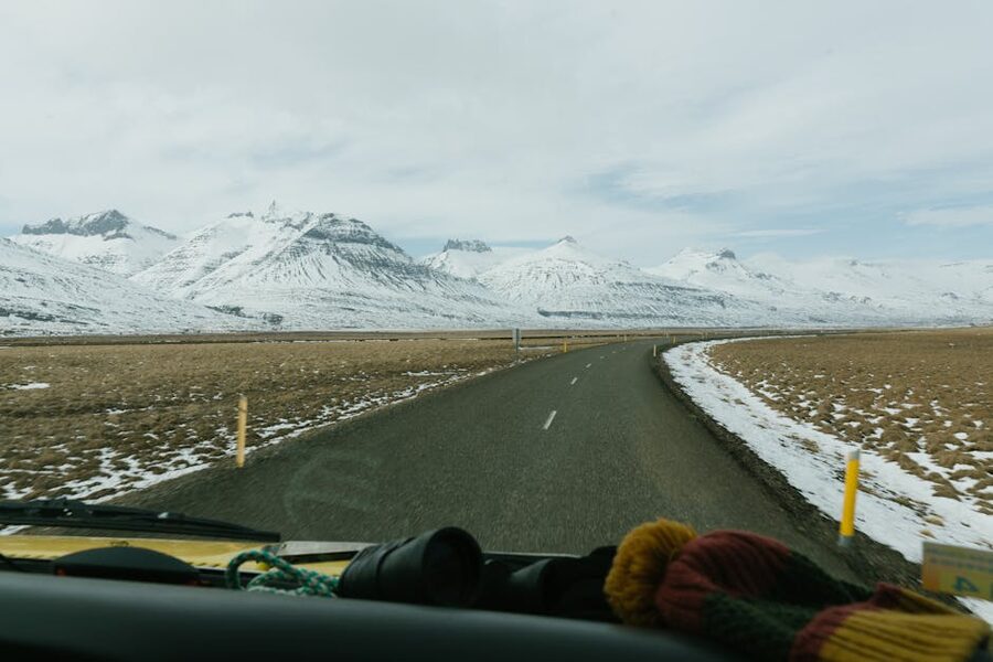 View from inside a car looking at snowy mountain range in Iceland