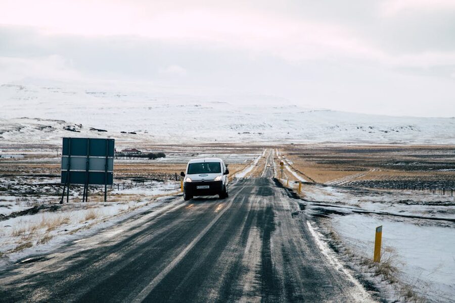 Empty road leading through snowy Icelandic landscape