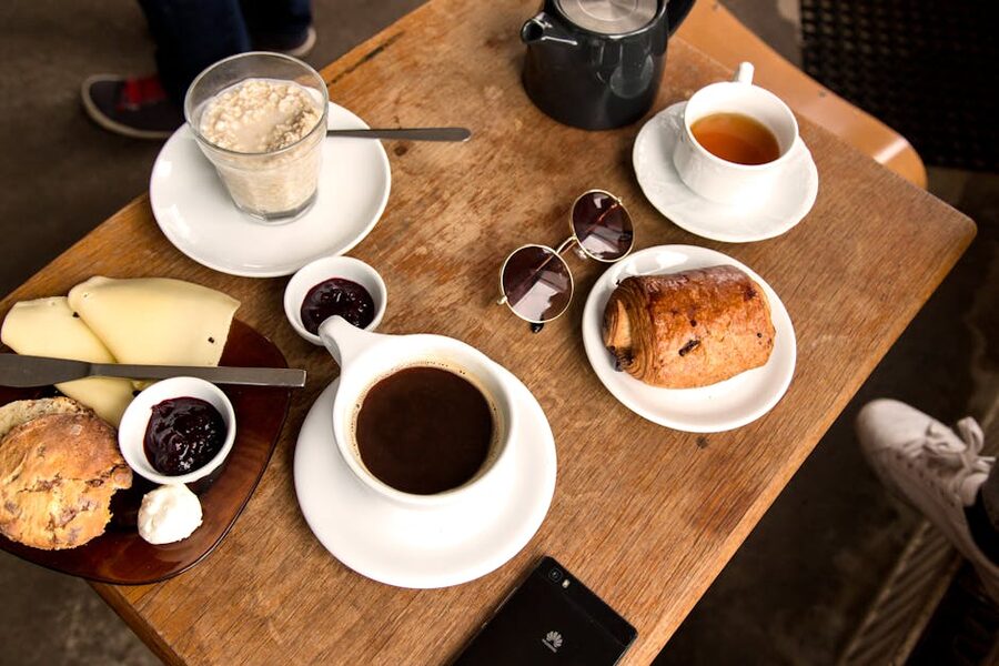 A cozy Icelandic breakfast setting with coffee, pastry, and tea on a wooden table