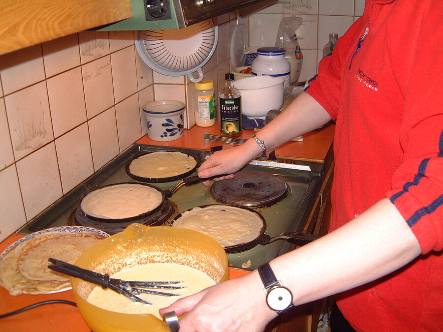 Pönnukökur Icelandic thin pancakes being made on a traditional stove