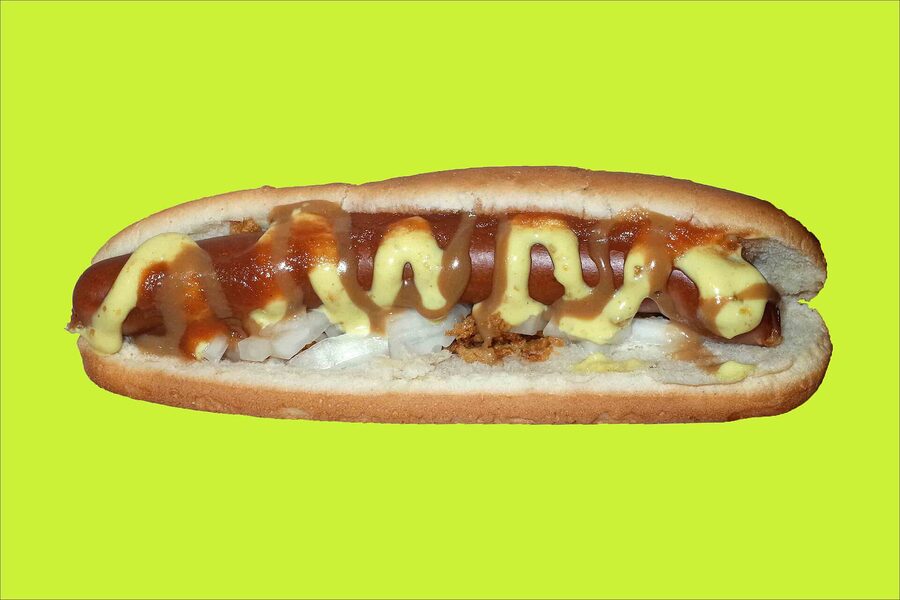 An Icelandic hot dog with everything — raw and fried onions, ketchup, mustard, remoulade