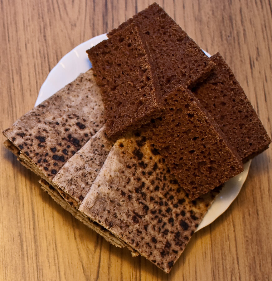 A plate of rúgbrauð rye bread and flatbrauð with traditional Icelandic toppings