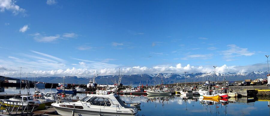 Husavik harbour with whale-watching boats moored at the dock