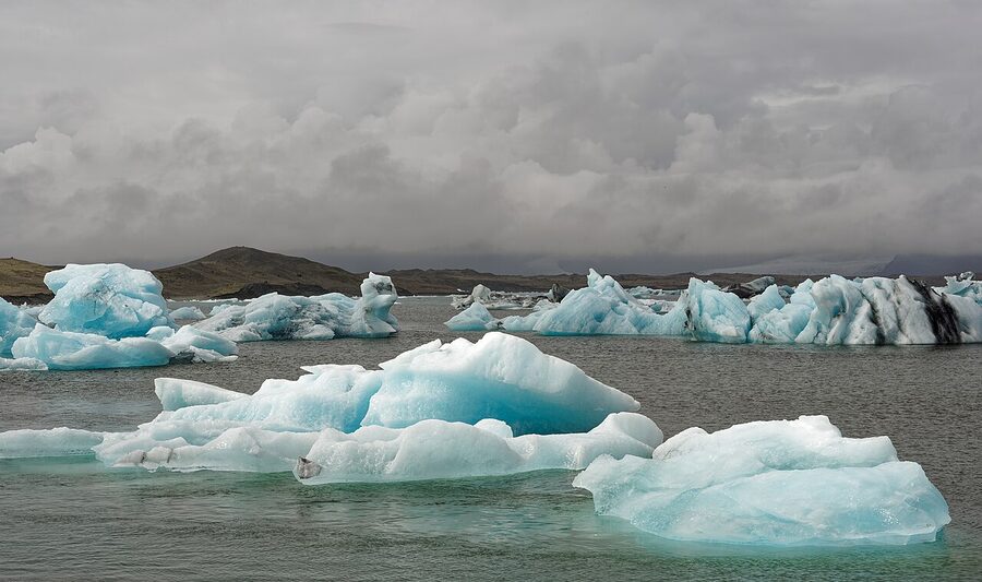 Icebergs floating across the calm waters of Jokulsarlon glacier lagoon