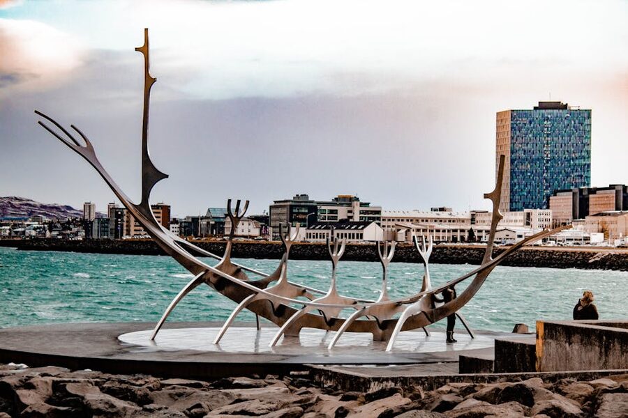 Sun Voyager sculpture on Reykjavik waterfront with city skyline