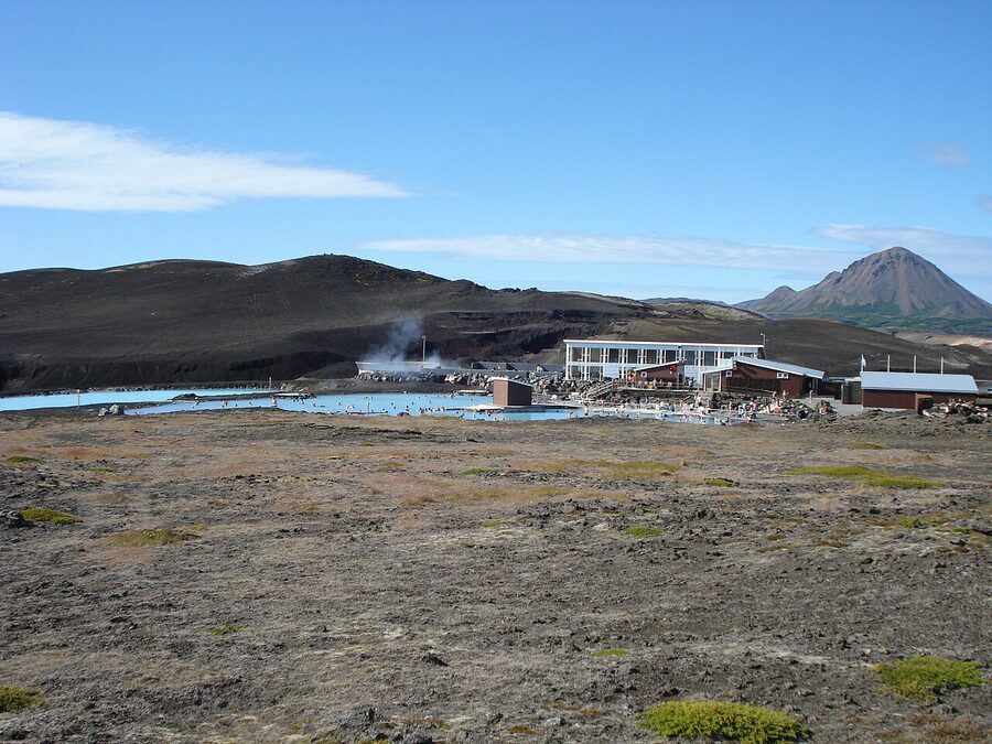 The blue water of Mývatn Nature Baths against the volcanic landscape