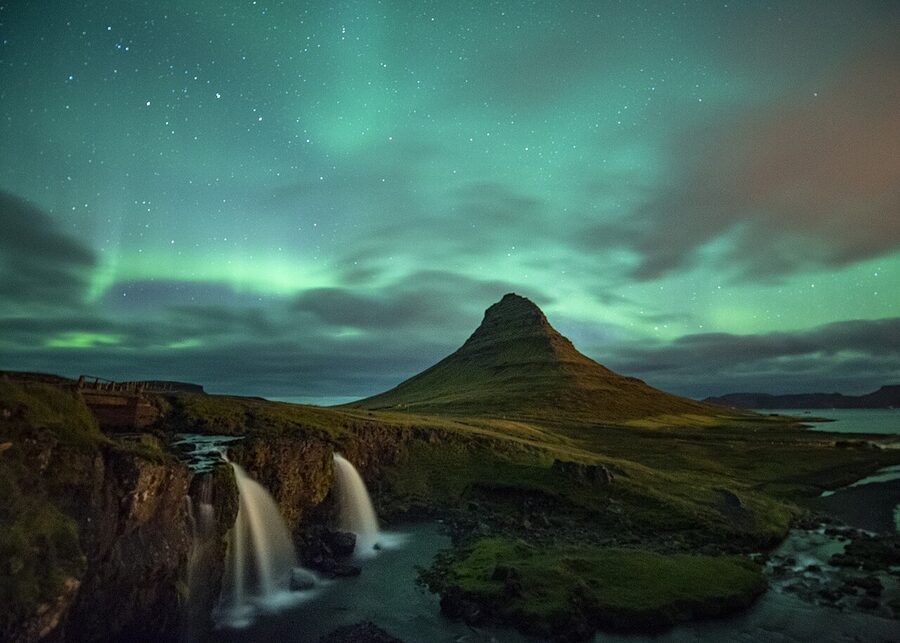 Aurora Borealis activity directly over Kirkjufell mountain