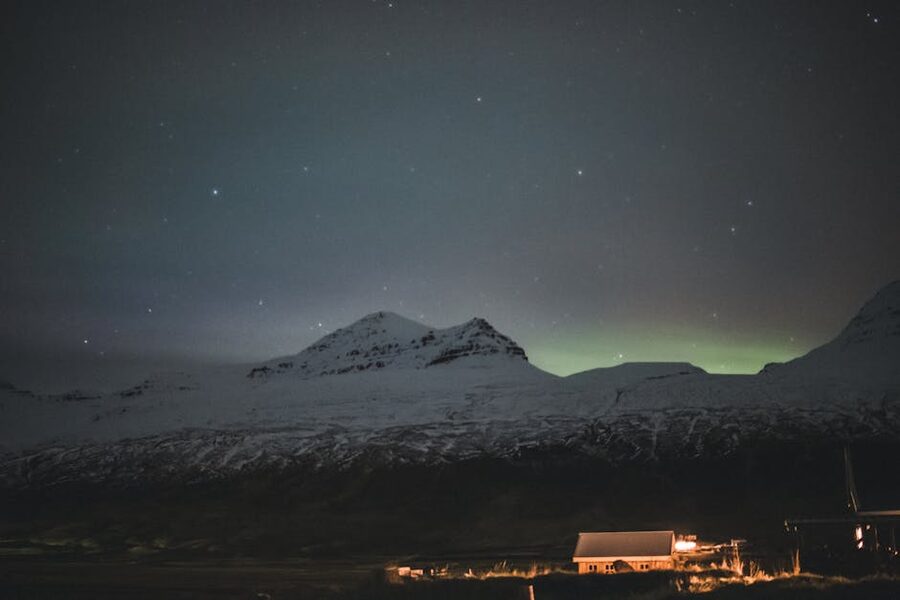 Aurora over snow-covered mountains in Iceland