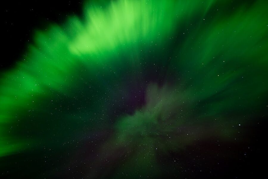 Vivid green aurora over Iceland with stars