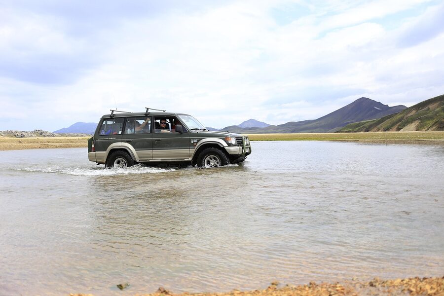 Off-road vehicle crossing a glacial river in Iceland