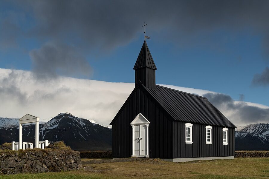 Budakirkja the black church at Budir on the Snaefellsnes peninsula with mountains