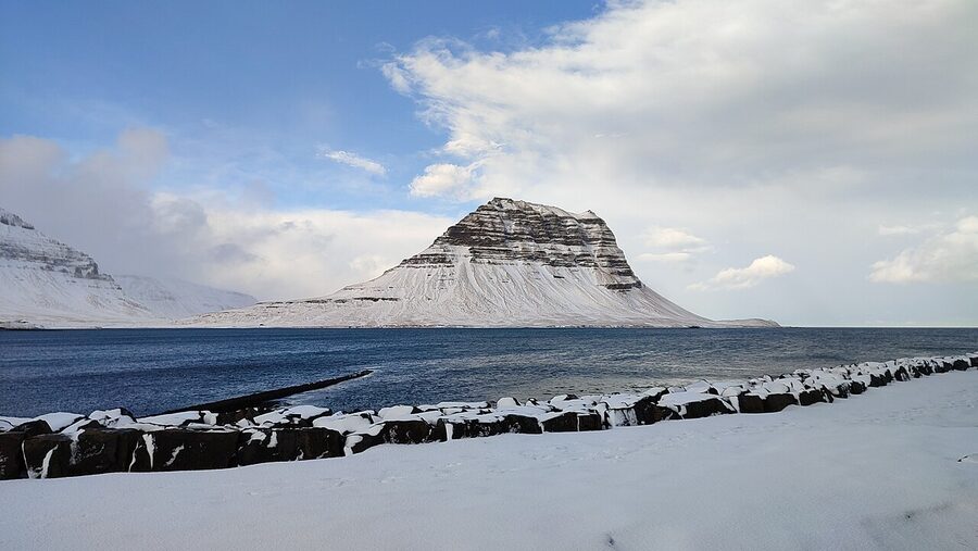 Kirkjufell mountain in winter with snow-covered peak