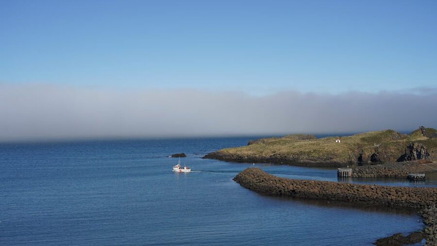 Small boat near rocky Icelandic coast