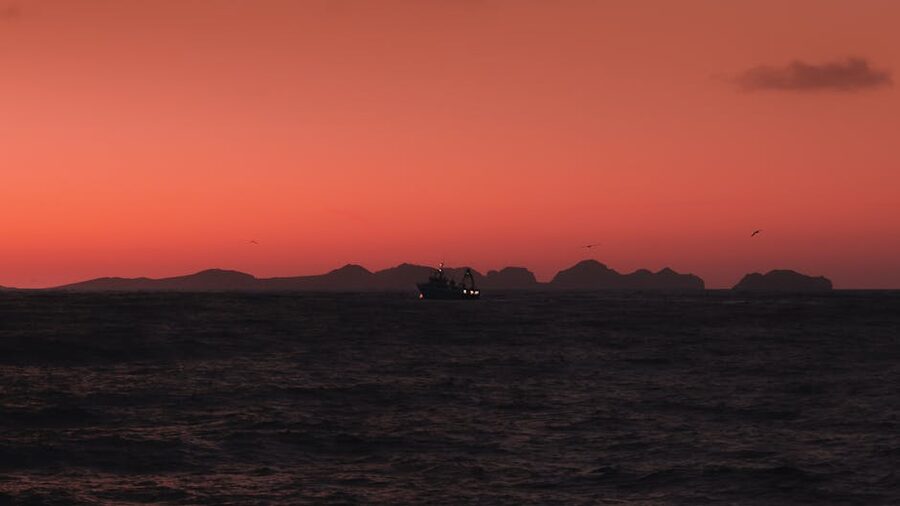 Boat at sunset with dramatic Icelandic sky